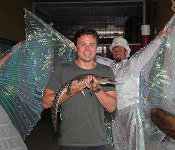 Man holding a baby crocodile