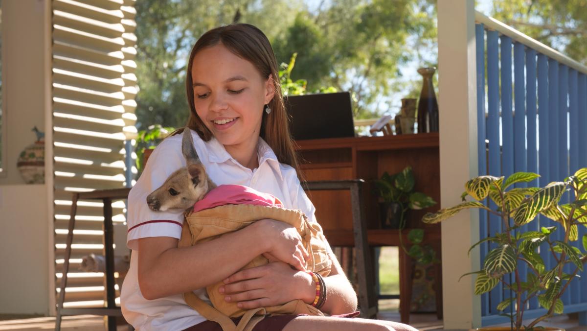 Lily Whiteley on the set of KANGAROO with an orphaned joey