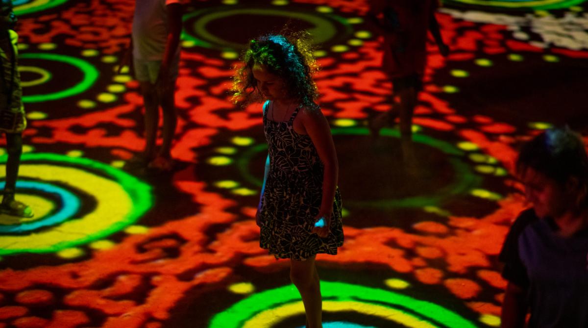 Children play at Grounded, Parrtjima. Grounded artwork Wild Flowers by Camilla Hayes