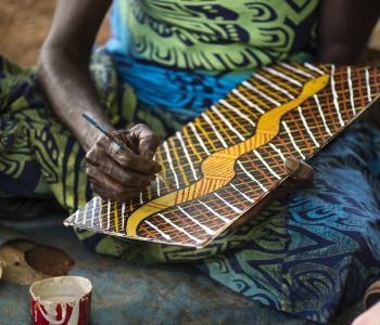 image of womans hand doing a bark painting