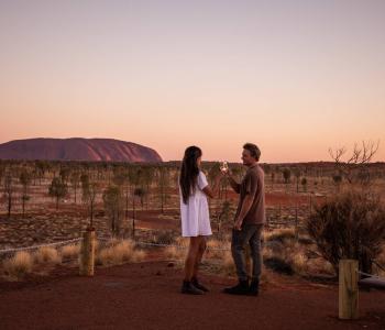 Couple watching sunset at Uluru