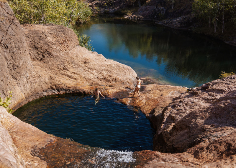 two people enjoy a swim in the creek at Surprise Falls