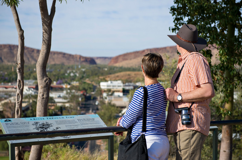2 people looking over the township of Alice Springs from on top of Anzac Hill